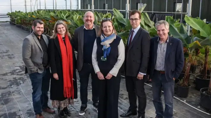 Cllr Leigh Frost, Jayne Kirkham MP, Perran Moon MP, Noah Law MP, Gus Grand, Piers Guy in a geothermal heated greenhouse at Eden’s Growing Point plant nursery