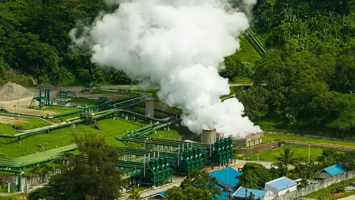 Geothermal_power_production_plant_with_steam_and_pipes
